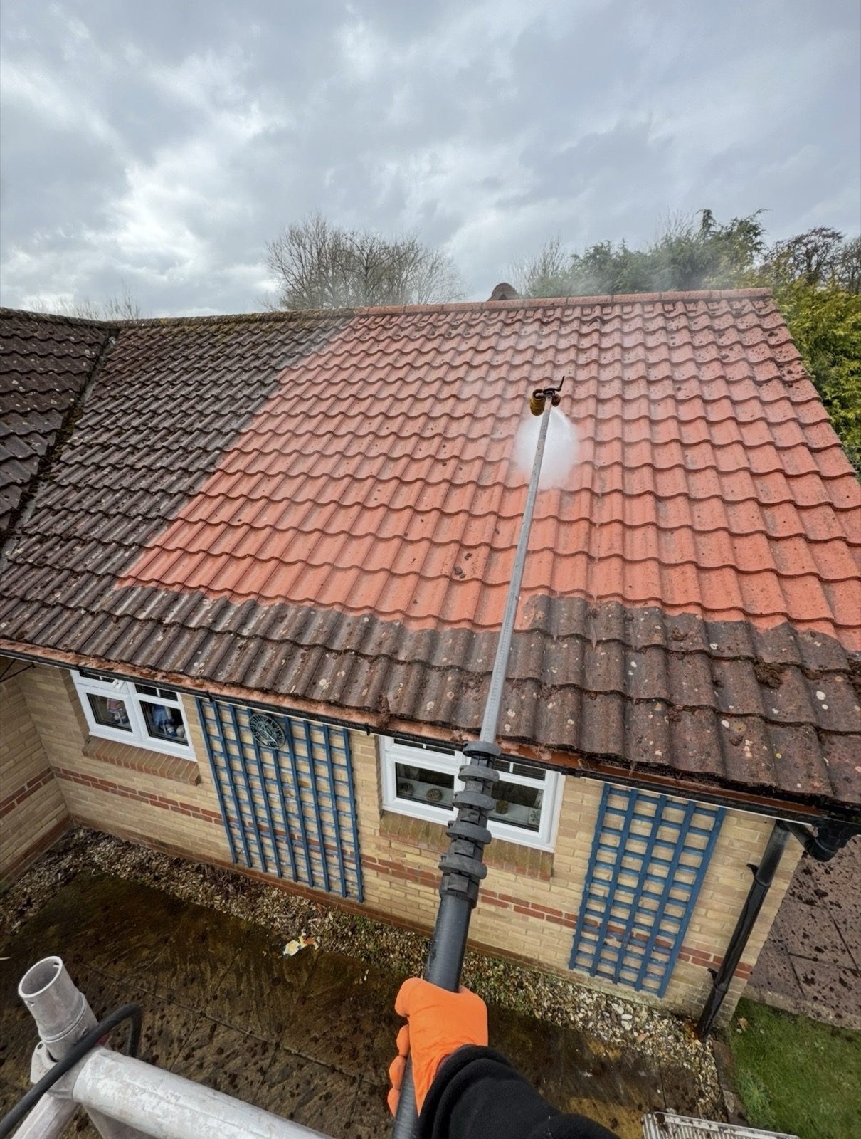 Biocide treatment being applied to a roof